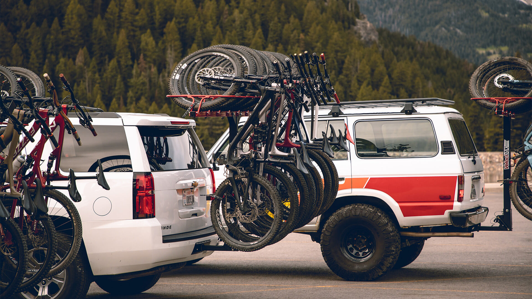 3 vehicles with loaded vertical hitch bike racks