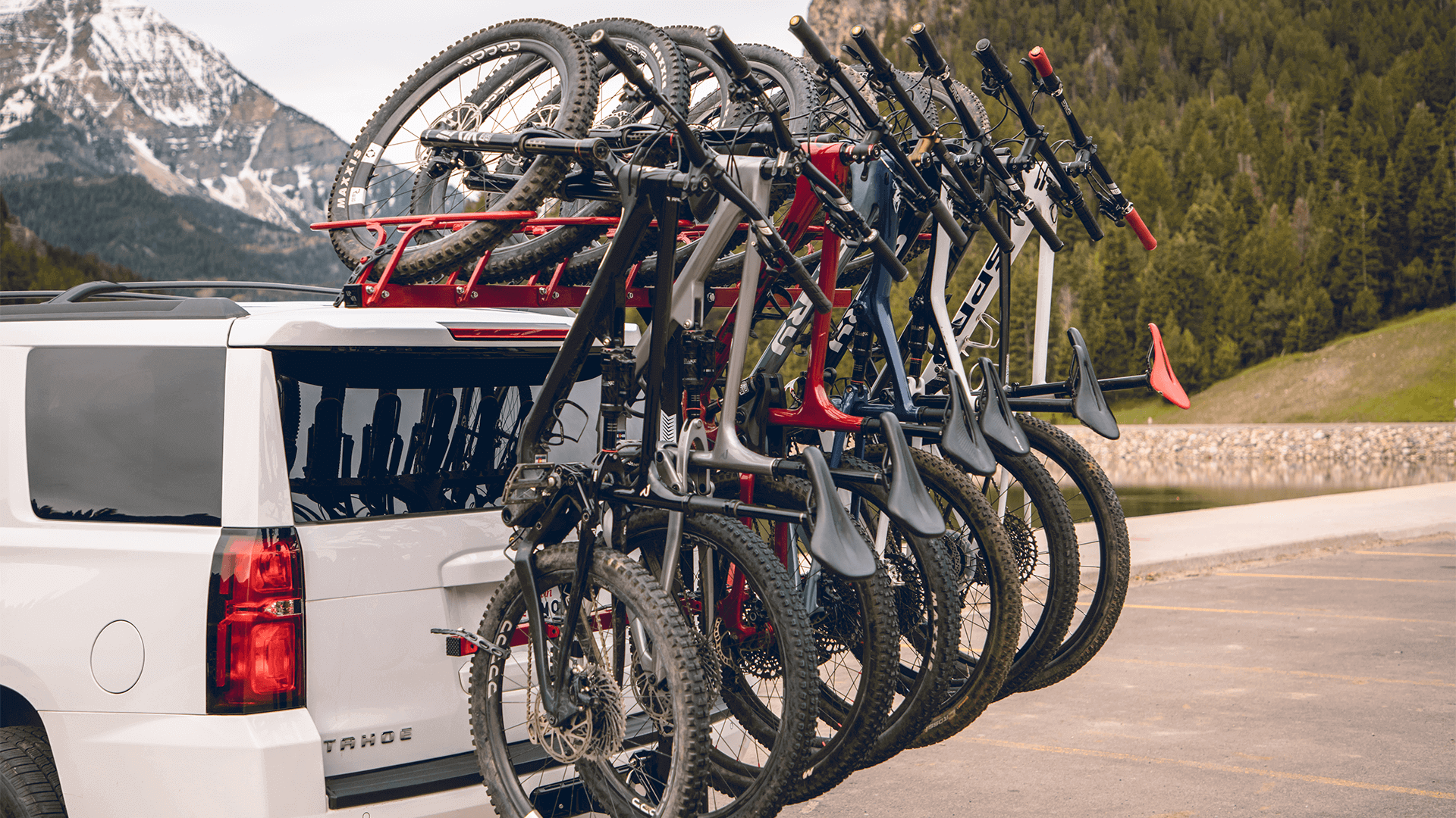 Chevrolet Tahoe with hitch mounted vertical bike rack with 7 bikes on it.