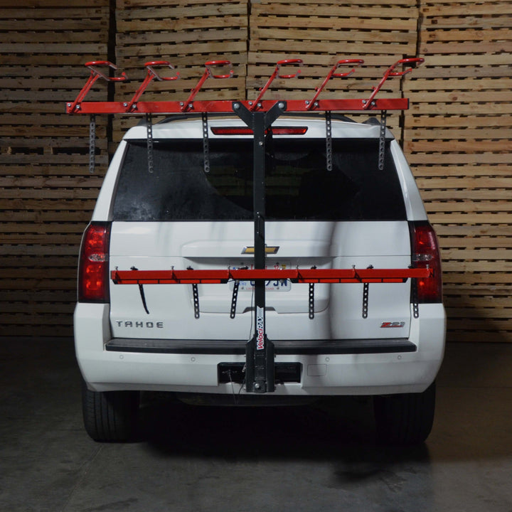 Un-illuminated light bar on a hitch mount vertical bike rack on the back of a Chevrolet Tahoe.